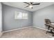 Bedroom with ceiling fan, a window with blinds, neutral walls, and a desk with a chair at 520 N Stapley Dr # 256, Mesa, AZ 85203