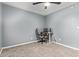 Bedroom with ceiling fan, a window with blinds, neutral walls, a desk, and a rolling chair at 520 N Stapley Dr # 256, Mesa, AZ 85203