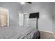 Bedroom with vaulted ceiling, fan, gray walls, carpet, bed, dresser with a tv at 520 N Stapley Dr # 256, Mesa, AZ 85203