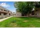 Lush green courtyard with mature trees and walking paths at 520 N Stapley Dr # 256, Mesa, AZ 85203