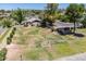 Wide angle view of a fenced dog park with mature trees and grass at 520 N Stapley Dr # 256, Mesa, AZ 85203