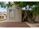 Exterior view of a two-story apartment complex with trees and brown gravel ground cover at 520 N Stapley Dr # 256, Mesa, AZ 85203