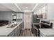 Bright kitchen features stainless steel appliances, gray cabinets and countertops, and wood-look floors at 520 N Stapley Dr # 256, Mesa, AZ 85203