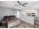 Open living space with a sofa, modern ceiling fan, and view into the kitchen at 520 N Stapley Dr # 256, Mesa, AZ 85203