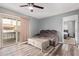 Living room with sliding glass doors to balcony and plush sofa, wood-look floors and ceiling fan at 520 N Stapley Dr # 256, Mesa, AZ 85203
