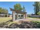 Pergola with picnic table in a grassy community area with landscaping at 520 N Stapley Dr # 256, Mesa, AZ 85203