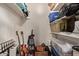 Spacious storage closet features plenty of storage space with shelves, guitars, vacuum, and plastic bins at 520 N Stapley Dr # 256, Mesa, AZ 85203