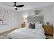 Bright bedroom with a tufted headboard, dresser, and modern ceiling fan at 5232 E Dodge St, Mesa, AZ 85205
