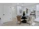 Elegant dining area with a modern black table, comfortable seating, and contemporary decor at 5232 E Dodge St, Mesa, AZ 85205