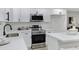 Bright kitchen featuring stainless steel appliances, white cabinetry, and quartz countertops at 5232 E Dodge St, Mesa, AZ 85205