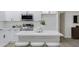 Bright kitchen featuring white cabinets, quartz countertops, stainless appliances, and an island with seating at 5232 E Dodge St, Mesa, AZ 85205
