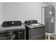 Modern laundry area with front-loading washer, dryer, and water heater at 5232 E Dodge St, Mesa, AZ 85205