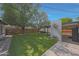 Backyard featuring manicured lawn, mature trees, patio, and unique architectural metal accents at 530 W Almeria Rd, Phoenix, AZ 85003