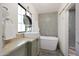 Bright bathroom featuring a soaking tub, stone tile, and modern vanity with granite countertop at 530 W Almeria Rd, Phoenix, AZ 85003