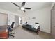 Bedroom with ceiling fan, desk, futon, closet, and neutral carpeting at 530 W Almeria Rd, Phoenix, AZ 85003