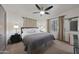 Serene bedroom featuring a ceiling fan, plush bedding, and soft natural light creating a tranquil space at 530 W Almeria Rd, Phoenix, AZ 85003
