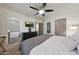 Relaxing bedroom featuring a ceiling fan, large bed, and access to a luxurious en-suite bathroom at 530 W Almeria Rd, Phoenix, AZ 85003