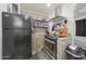 Compact kitchen area with stainless steel appliances and unique decor at 530 W Almeria Rd, Phoenix, AZ 85003
