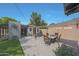 Outdoor patio area featuring a dining table with chairs, lounge seating, and a shade structure at 530 W Almeria Rd, Phoenix, AZ 85003