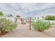 Spacious backyard with desert landscaping, an outdoor seating area, and mature cacti at 5410 E University Dr, Mesa, AZ 85205