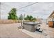 Backyard oasis featuring a hot tub, patio, and desert landscaping, perfect for relaxing and entertaining outdoors at 5410 E University Dr, Mesa, AZ 85205