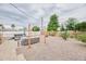 This backyard retreat includes a comfortable seating area, desert landscaping, and a fire pit at 5410 E University Dr, Mesa, AZ 85205