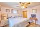 Charming bedroom with a white bed frame, ceiling fan, and two dressers at 5410 E University Dr, Mesa, AZ 85205