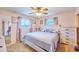 Comfortable bedroom with two windows, ceiling fan and matching dressers on either side of the bed at 5410 E University Dr, Mesa, AZ 85205