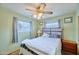 Bright bedroom with two windows, a ceiling fan, and green walls at 5410 E University Dr, Mesa, AZ 85205