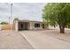 Charming single-story home featuring a covered carport and a well-maintained gravel front yard at 5410 E University Dr, Mesa, AZ 85205