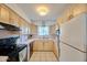 Efficient kitchen layout featuring ample storage, a black stove, and views out to the backyard at 5410 E University Dr, Mesa, AZ 85205