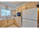 Functional kitchen with ample cabinetry, bright countertops, and a classic sink and window at 5410 E University Dr, Mesa, AZ 85205