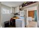The laundry room has a washer, dryer, storage cabinets, tile floors, and white brick at 5410 E University Dr, Mesa, AZ 85205