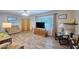 Inviting living room with wood-look floors, large window views, and comfortable reclining furniture at 5410 E University Dr, Mesa, AZ 85205