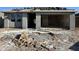 Unfinished home exterior shows stucco walls and garage with materials on the roof awaiting installation at 5515 W Piedmont Rd, Laveen, AZ 85339