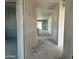 Unfinished hallway features blank drywall and leads to a bright opening, showing the building's progress at 5515 W Piedmont Rd, Laveen, AZ 85339