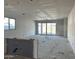 Unfinished living space with windows and sliding glass doors, displaying the building's potential for entertainment and light at 5515 W Piedmont Rd, Laveen, AZ 85339