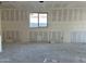 Unfinished living area shows drywall, a window, and rough flooring, highlighting the building's potential at 5515 W Piedmont Rd, Laveen, AZ 85339