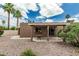 The backyard features a covered patio and beautiful desert landscaping with lush greenery and palm trees at 5526 N 77Th Way, Scottsdale, AZ 85250