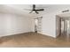 Bright bedroom features sleek wood-look floors, barn door bathroom entry and a contemporary ceiling fan at 5526 N 77Th Way, Scottsdale, AZ 85250