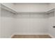 Walk-in closet featuring white shelving and rod system for organized storage solutions at 5526 N 77Th Way, Scottsdale, AZ 85250