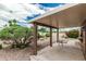 Charming covered patio features a gravel landscape with beautiful bushes and a small table at 5526 N 77Th Way, Scottsdale, AZ 85250