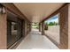 Relaxing covered patio with sliding glass doors and neutral colors offers a seamless indoor-outdoor living experience at 5526 N 77Th Way, Scottsdale, AZ 85250