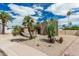 Beautiful home showcasing desert landscaping with palm trees, cacti, and a concrete driveway at 5526 N 77Th Way, Scottsdale, AZ 85250