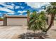 Home featuring desert landscaping and a two-car garage with a concrete driveway and palm trees at 5526 N 77Th Way, Scottsdale, AZ 85250