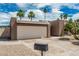 Home featuring desert landscaping, palm trees, and a two-car garage with a concrete driveway at 5526 N 77Th Way, Scottsdale, AZ 85250