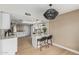 Kitchen with bar seating, pendant lighting and a view of the eat-in kitchen at 5526 N 77Th Way, Scottsdale, AZ 85250