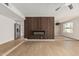 Open-concept living room with electric fireplace and hardwood floors at 5526 N 77Th Way, Scottsdale, AZ 85250