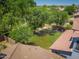 Aerial view of the backyard featuring a large grass area and mature trees at 567 E Tropical Dr, Casa Grande, AZ 85122