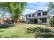 A sprawling backyard features mature trees and covered patio at 567 E Tropical Dr, Casa Grande, AZ 85122